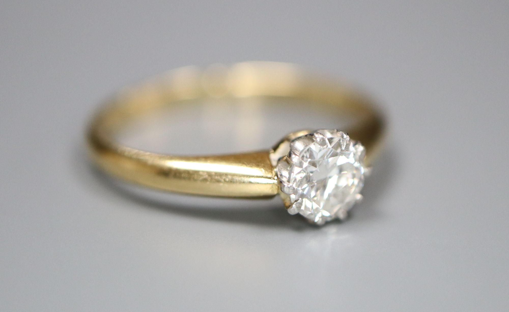 An 18ct and solitaire diamond ring, size G, gross 1.7 grams.